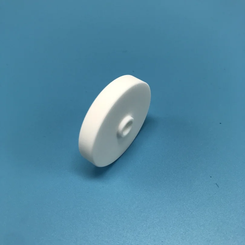 H35a89387e1604845b28928f253ad88c2s.webp Customized Macor Ceramic Sheet Machinable Glass Ceramic Disc with a Hole - Image 1