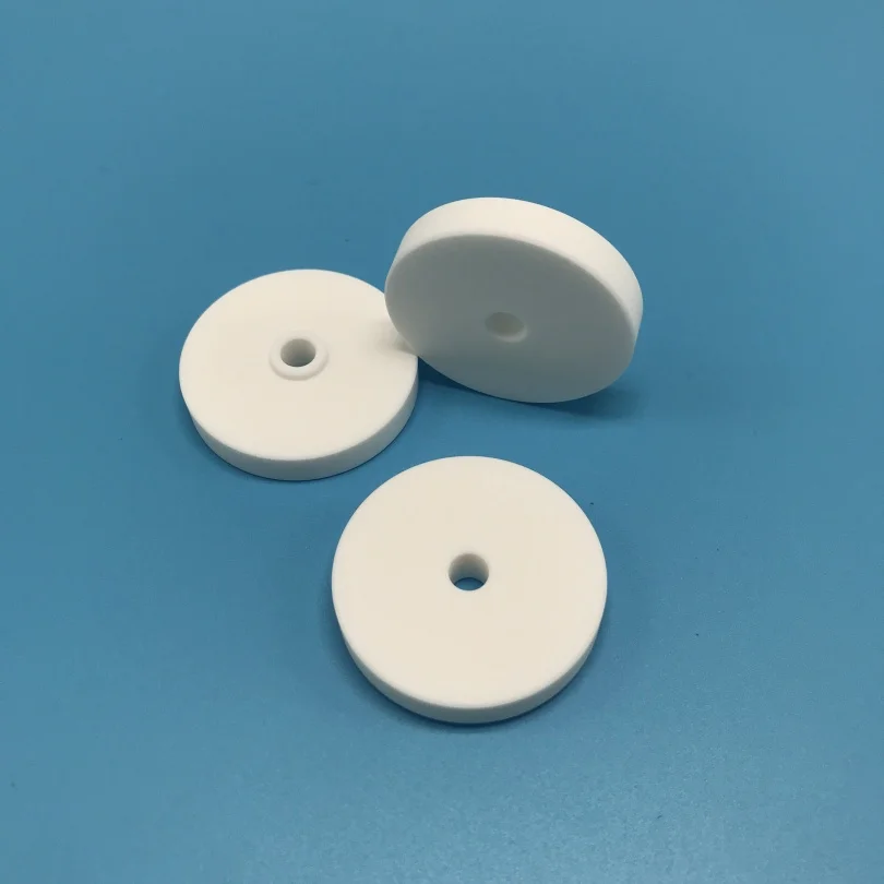 H87bfd0ac9e5f40c88274eff1489e2fc24.webp Customized Macor Ceramic Sheet Machinable Glass Ceramic Disc with a Hole - Image 1